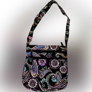 Vera Bradley. Great crossbody purse/features 3 separate zippered compartments.